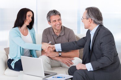 portrait of mature consultant shaking hand with happy woman
