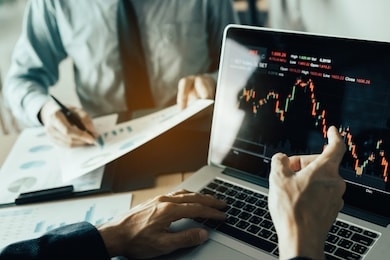 investors are pointing to laptops that have investment information stock markets and partners taking notes and analyzing performance data.