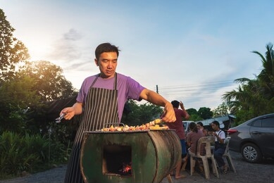bbq party group of people at barbecue dinner friends having food together outdoor as summer with friendship asian person.