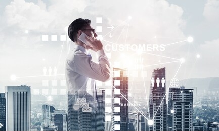 double exposure of elegant businessman standing facing the city and talking his mobile phone