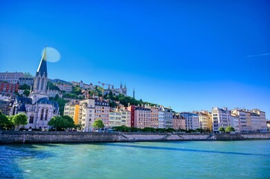 a view of lyon, france along the saone river in the afternoon.