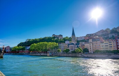 a view of lyon, france along the saone river in the afternoon.