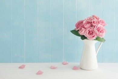 rose placed on the desk in blue background