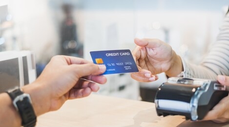 customer using credit cart for payment to owner at cafe restaurant, cashless technology and credit card payment concept