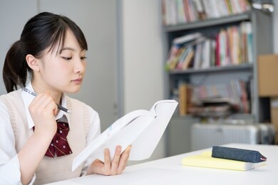 young asian student studying in room.