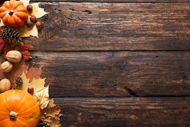 thanksgiving or autumnal holiday background, top view, copy space. autumnal holiday composition with pumpkins, nuts, yellow leaves.