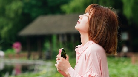 summer woman holding watermelon slice with eyes closed. smiling chinese girl eating watermelon in park. holiday lifestyle. brunette woman eat fresh watermelon. happiness, joy, holiday, summer concept.