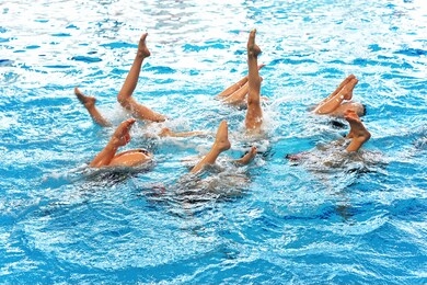  synchronized swimming. legs out of the water