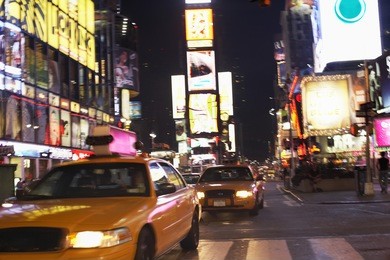 yellow taxis on city street at night