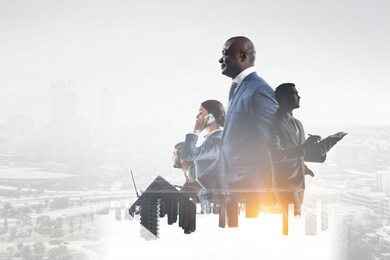 happy black businessman with other people working in office on cityscape background