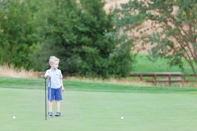 cute little boy at the golf course
