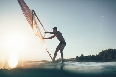 low angle view of windsurfer sailing on the windsurf board