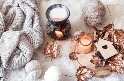 autumn and winter home still life . the view from the top. the concept of home atmosphere and decor. wooden houses with carved heart and autumn golden leaves.