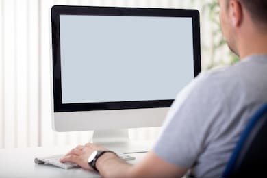 man in front of computer screen