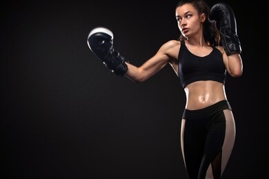 woman boxer on black background. boxing and fitness concept.