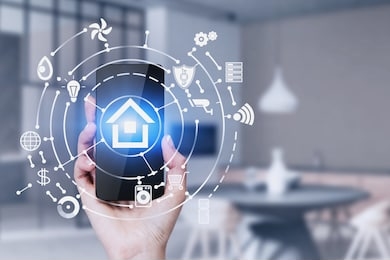 hand of woman holding smartphone in blurred kitchen with double exposure of smart home interface. concept of automation.