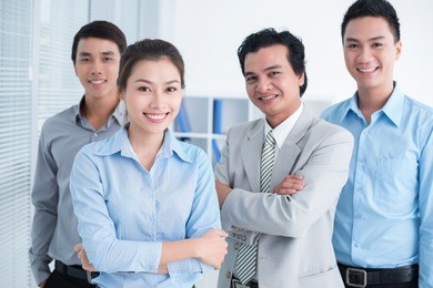 portrait of smiling businesspeople, standing and posing at camera