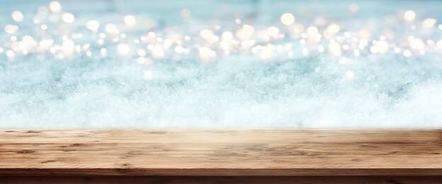 abstract winter panorama with wooden table and bright bokeh for a christmas decoration
