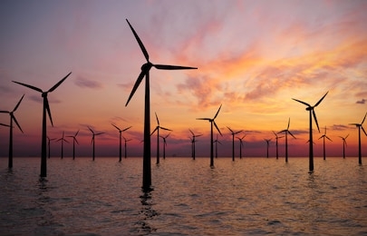 offshore wind turbines farm at sunset