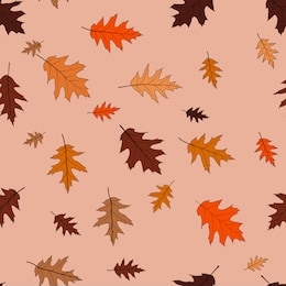 the leaves of red oak, bronze shades on a beige background. seamless pattern