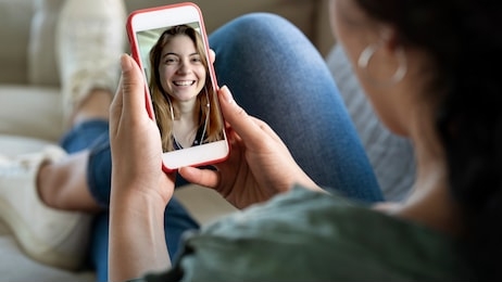 young woman using smartphone for video call