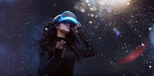 beautiful woman with flowing hair in futuristic dress over dark magic light background. girl in glasses of virtual reality. augmented reality, game, future technology concept. vr.