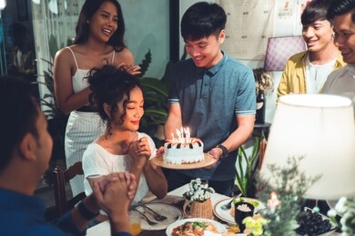 asian friends group celebrating at a birthday party she wishes to bless the birthday