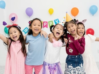 happy group of five little girl, kindergarten kids or pre-teen friend, arm around standing and smiling fun celebration party. birthday or childhood, holidays, friendship concept
