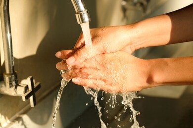 hand of beauty woman  wash your hands at the wash basin with foam, cleanse the skin and have water flowing through the hands. health and beauty concepts