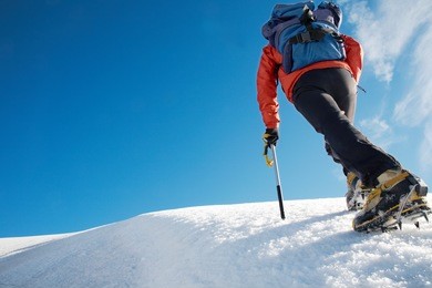 lone male mountain climber climbing a snowy ridge; mont blanc, europe.