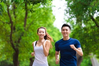 happy young couple jogging and running  in park