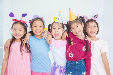 group of adorable asian girls having fun at birthday party

