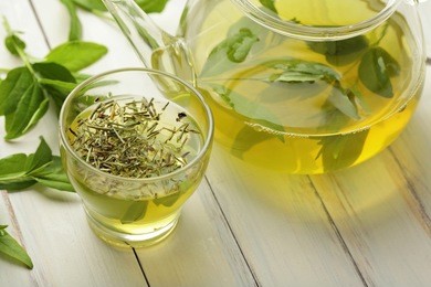 healthy green tea cup with tea leaves 