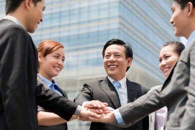 close-up of a happy business team posing in front of the modern building