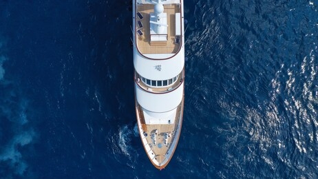 aerial top view photo of luxury yacht docked in mediterranean deep blue sea