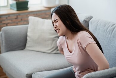 closeup picture of a woman with stomachache, menstrual cramps torture.