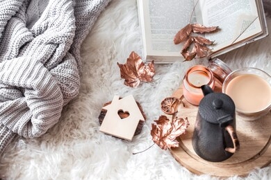 autumn and winter home still life . the view from the top. the concept of home atmosphere and decor. wooden houses with carved heart and autumn golden leaves.