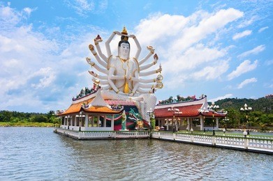 statue of eighteen arms buddha. part of temple complex wat plai laem on samui island. thailand, koh samui
