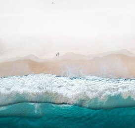 beautiful beach and water at sunrise with people standing in front of wave and on white sand on the gold coast. queensland new south wales brisbane byron bay sunshine coast noosa bondi manly