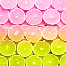 creative pattern. fresh sliced orange fruit texture, neon colors. macro, top view with copy space. food frame. juicy oranges in trendy rainbow gradient color background. banner.