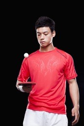 man playing ping pong, black background