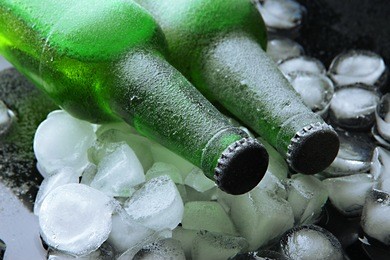 bottles of beer with ice cubes, close up