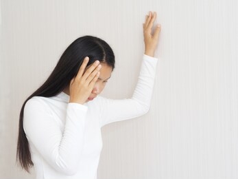 vertigo illness  and vertigo and sick building syndrome or sbs, brain atrophy in asian woman, she use hand touching head and felling headache dizzy sense use for health care concept.