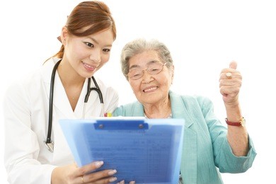 smiling asian medical doctor and senior woman