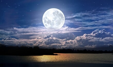 full moon and cloudy sky over the night lake
