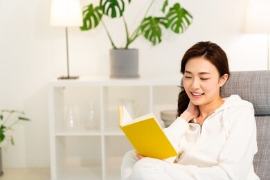 young attractive asian woman who reads a book