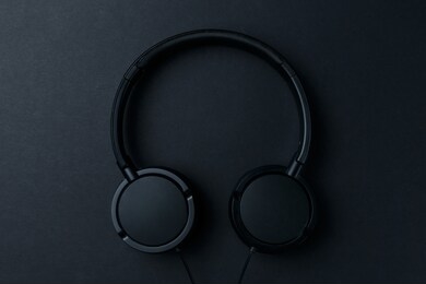 headphone. music concept. flat lay: headphones on black background. top view. trendy colorful photo. black headphones on yellow background. music concept. minimal style