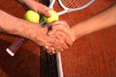 shaking hands on tennis court