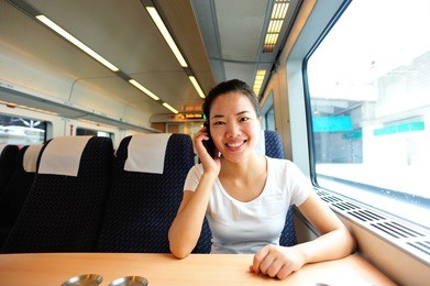 young asian woman use smartphone interior of train/subway