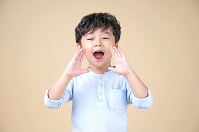 asian little boy shout with happy wow surprised face